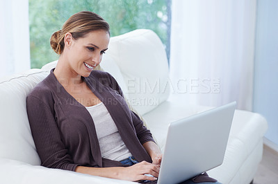 Buy stock photo Woman, laptop and relax on sofa for remote work, update blog post and digital news on social media at home. Happy freelancer, computer and person on house living room couch with website technology