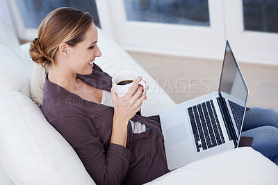 Buy stock photo Relax, laptop and happy woman on a sofa with coffee while streaming movie, film or video at home. Pc, internet or female person in a living room with tea, break or social media, subscription or show