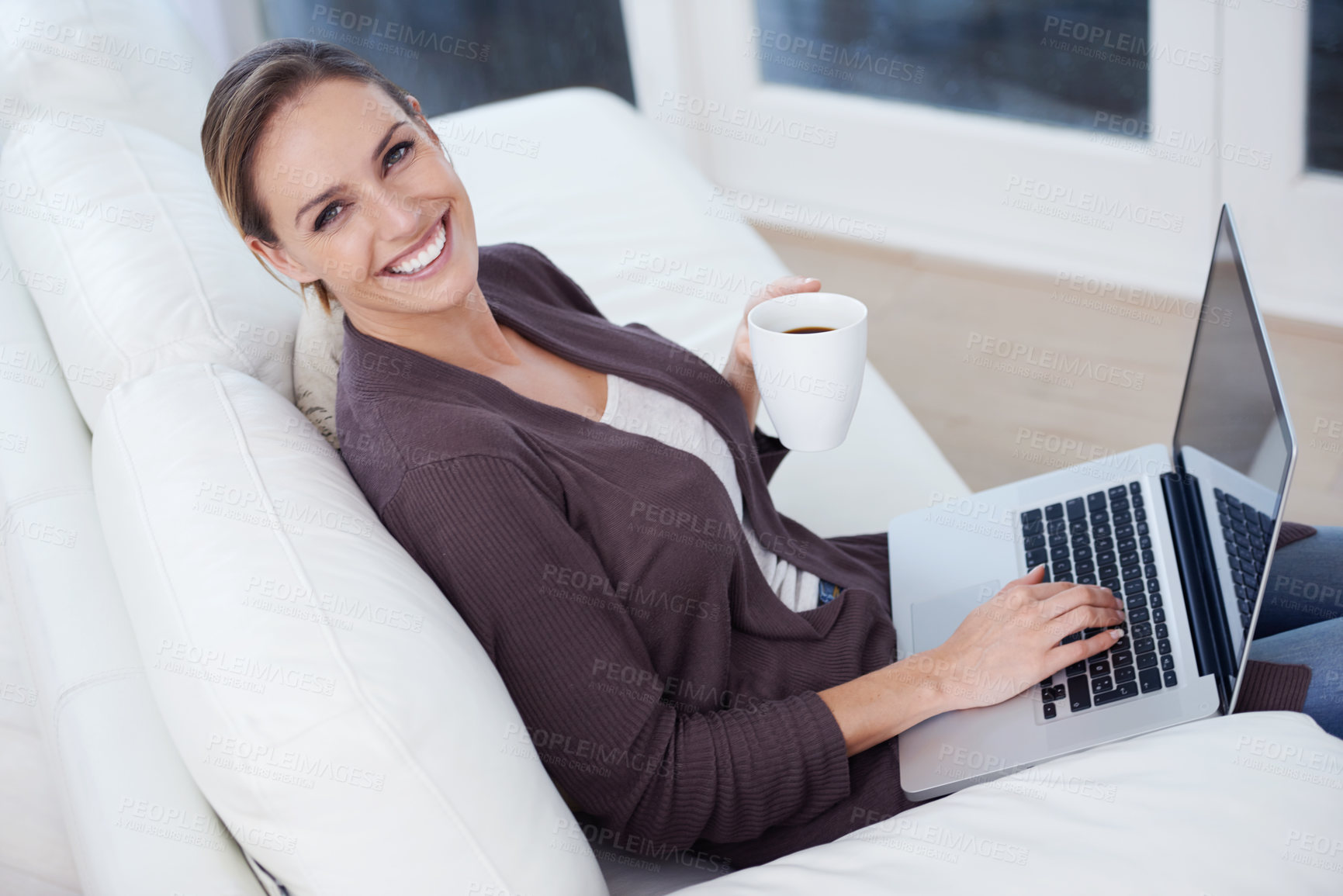 Buy stock photo Portrait, laptop and happy woman on a sofa with coffee while streaming movie, film or video at home. Pc, face or female person in a living room with tea, break or social media, subscription or show