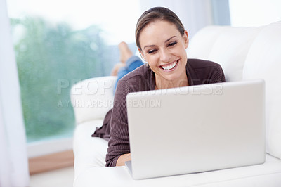 Buy stock photo Happy woman, laptop and relax on couch for remote work, streaming movies and update blog post at home. Freelancer, computer and download subscription, online shopping and search news on social media 