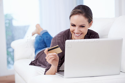 Buy stock photo A young woman doing online shopping