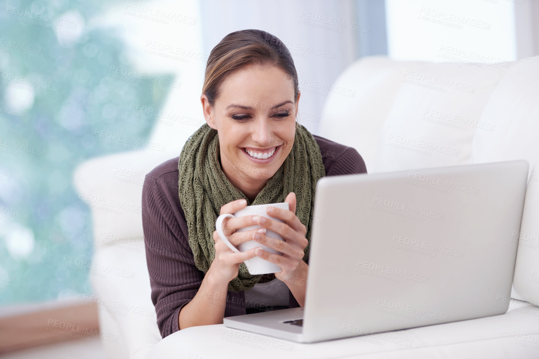 Buy stock photo Laptop, relax and happy woman on a sofa with coffee while streaming movie, film or video at home. Pc, smile or female person in a living room with tea, break or social media, subscription or show