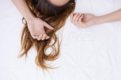 Buy stock photo Woman, hair and lying on bed in relax for morning, sleep or rest in comfort, sheet or duvet cover at home. Top view or closeup of female person, brunette or model hands resting in bedroom on mockup