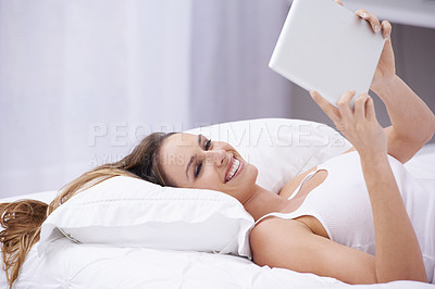 Buy stock photo Happy woman, bed and relax with tablet for social media, communication or networking at home. Female person smile lying in bedroom on pillow with technology for online streaming or entertainment