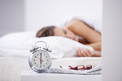 Buy stock photo Sleeping, morning and woman in bed with alarm for snooze, wake up and start day in home. Lazy, tired and person resting, dreaming and relaxing in bedroom with time, clock and glasses in house 