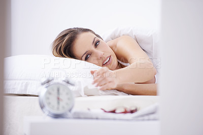 Buy stock photo Sleeping, bed and woman with alarm for snooze, wake up and morning routine in home. Lazy, tired and person resting, dreaming and relax in bedroom with time, clock and ring to start day in apartment 