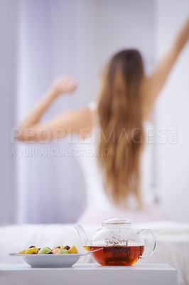 Buy stock photo Breakfast, tea and woman in bedroom, stretching with fruit salad for good diet and nutrition. Healthy food, herbal drink and wake up, girl on bed getting ready to start day in home or hotel from back