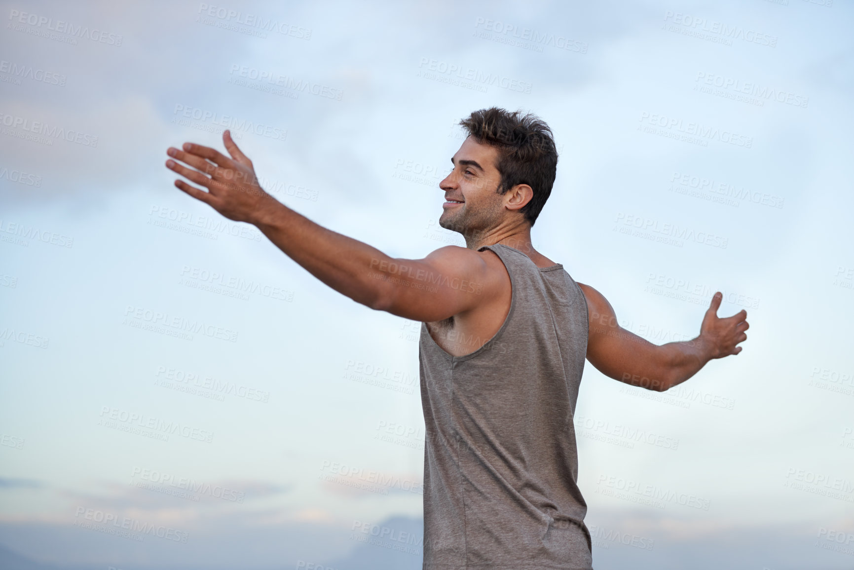 Buy stock photo Sky, happy and excited with man, vacation and journey with wellness and freedom with adventure. Person, outdoor and guy with arms raised, peace and happiness with holiday and adventure with smile