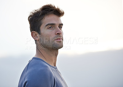 Buy stock photo A handsome young man looking away thoughtfully