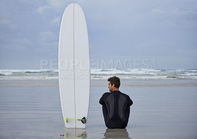 Buy stock photo Beach, fitness and man thinking with a surfboard for wellness, sports and training while sitting in nature. Water, exercise and back of male surfer at the ocean with peace, calm and sea hobby in Bali