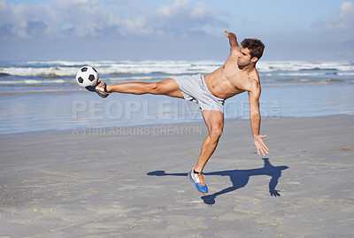 Buy stock photo Man, beach and kicking soccer ball for game, sports or exercise in outdoor hobby, training or practice. Young muscular male person or football player in match or cardio workout by ocean coast or sea