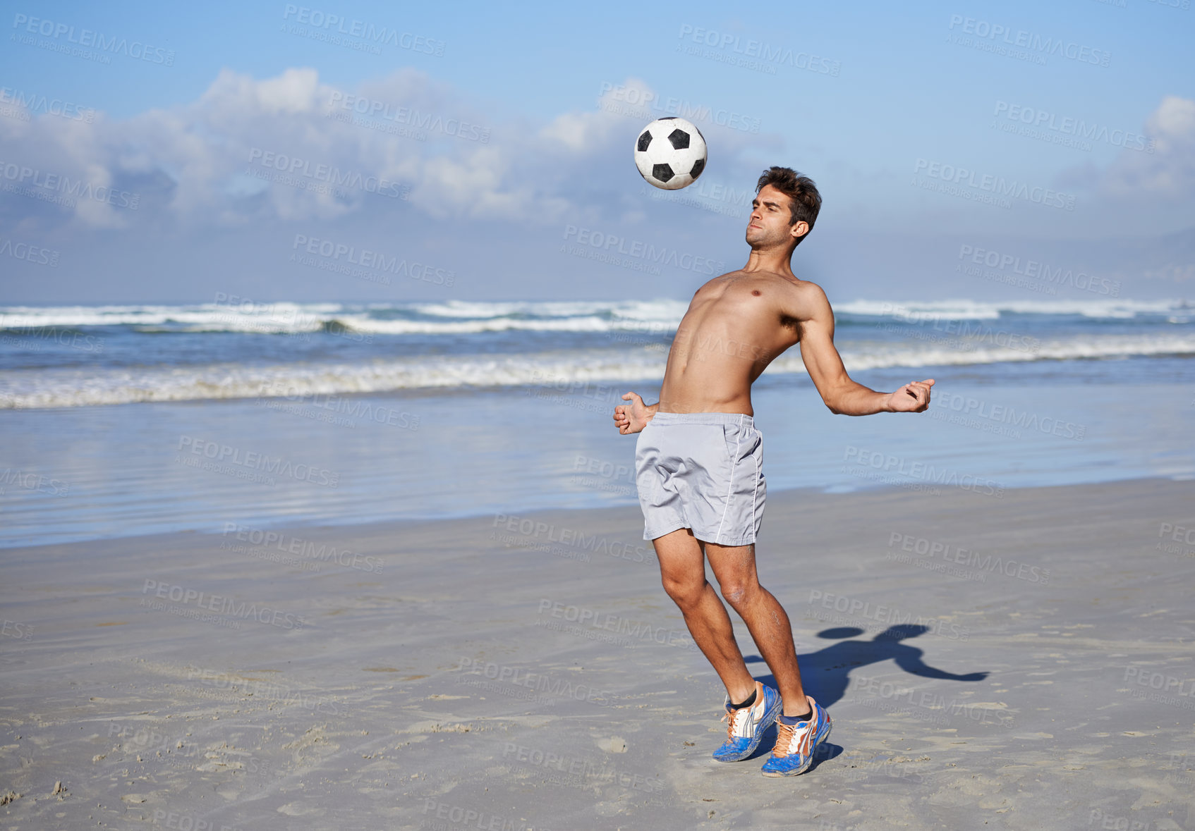 Buy stock photo Man, beach and playing with soccer ball for game, sports or exercise in outdoor hobby, training or practice. Young muscular male person or football player in match or cardio workout by ocean coast