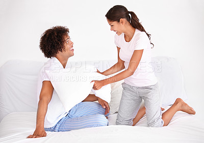 Buy stock photo Man, woman and pillow fight or bed playful on morning holiday in love connection, funny or vacation. Happy partnership, cushion and pajamas or laughing in home for game couple or comedy, joy or smile