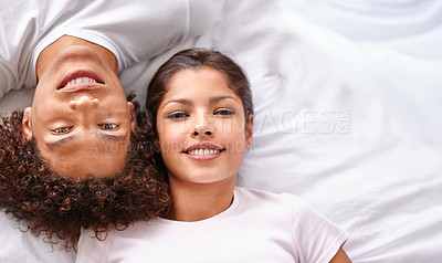 Buy stock photo A high angle view of a young couple lying on their bed