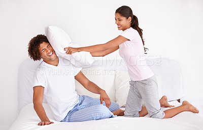 Buy stock photo Man, woman and pillow fight in morning on bed for holiday love connection, funny or vacation. Happy partnership, cushion and pajamas or laughing game in home for playing couple comedy, joy or smile