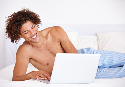 Buy stock photo Laptop, bedroom and relax man laughing at funny communication, social media meme and reading morning news. Comedy joke, network connection and person search internet for meme on home bed