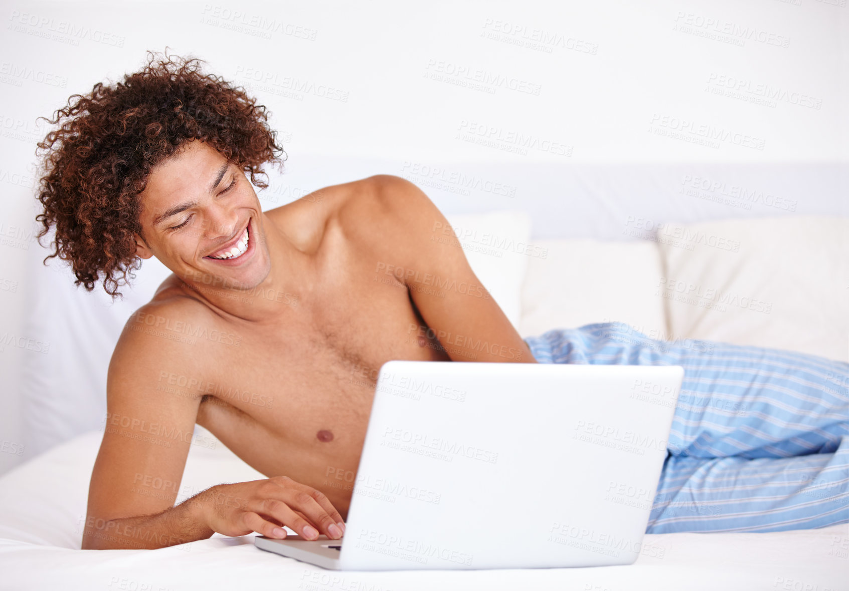 Buy stock photo Laptop, bedroom and relax man laughing at funny communication, social media meme and reading morning news. Comedy joke, network connection and person search internet for meme on home bed