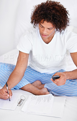 Buy stock photo Working, man in bedroom and cellphone for work from home, writing and sitting in pyjamas for freelance. Technology, entrepreneur and remote worker for online job, documents and business projects
