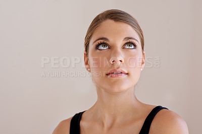 Buy stock photo Studio shot of an pretty young woman looking up at copyspace