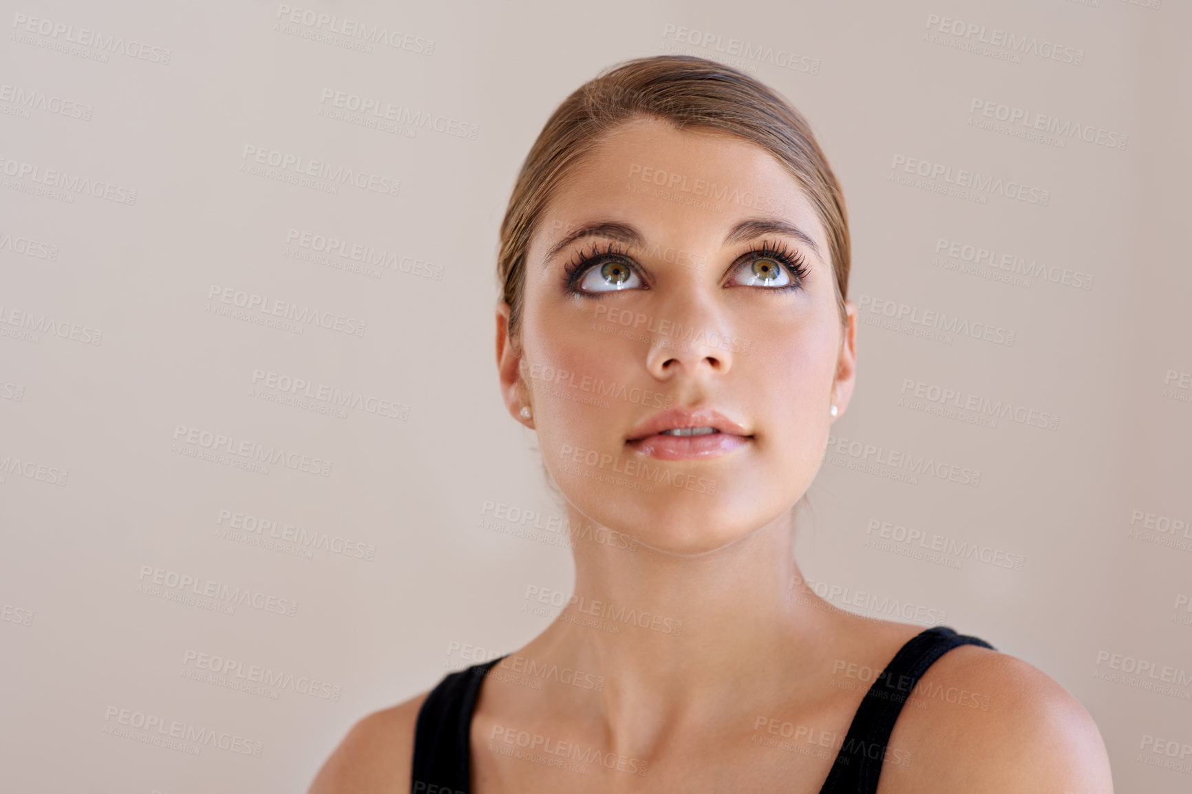 Buy stock photo Studio shot of an pretty young woman looking up at copyspace