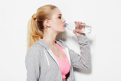 Buy stock photo Woman, drinking water and workout in studio profile, thinking and vision for fitness by white background. Girl, model and person with bottle, liquid and hydration for detox, wellness and nutrition