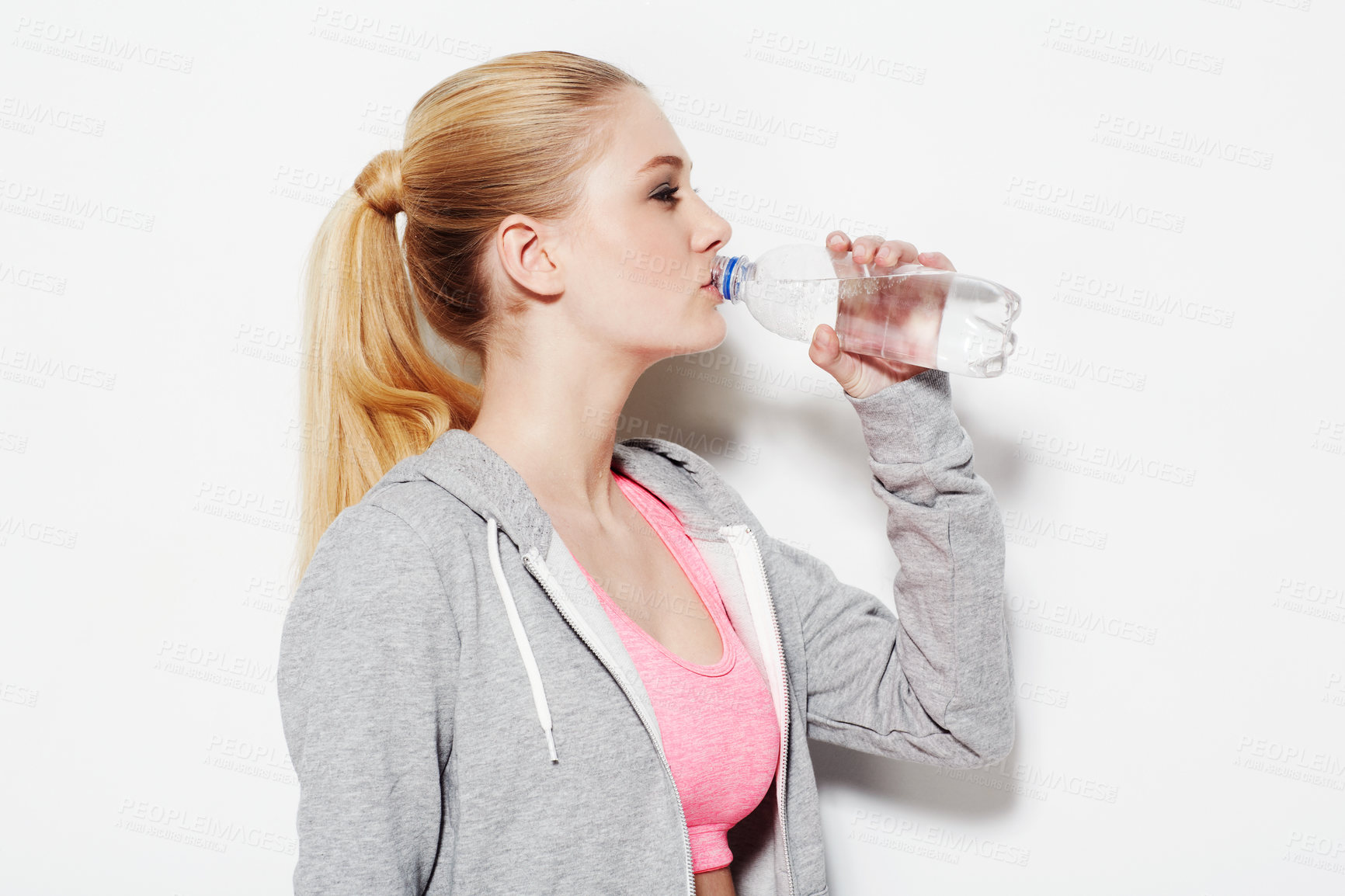 Buy stock photo Woman, drinking water and workout in studio profile, thinking and vision for fitness by white background. Girl, model and person with bottle, liquid and hydration for detox, wellness and nutrition