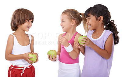 Buy stock photo Talking, apple or happy kids in studio with nutrition, wellness or healthy diet isolated on white background. Laughing, fiber or group of a young children with natural fruits for vitamin c with smile