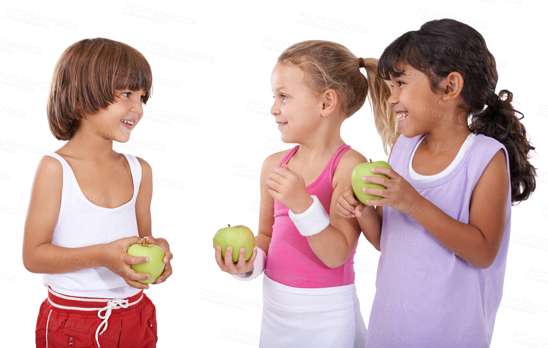 Buy stock photo Talking, apple or happy kids in studio with nutrition, wellness or healthy diet isolated on white background. Laughing, fiber or group of a young children with natural fruits for vitamin c with smile