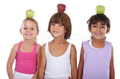 Buy stock photo Portrait, apple or happy kids in studio with nutrition, wellness or healthy diet isolated on white background. Head, balance or group of a young children with natural fruits for vitamin c with smile