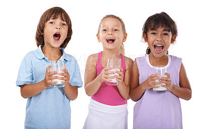 Buy stock photo Happy, children and portrait with milk in glasses for nutrition, health and energy in white background of studio. Calcium, drink and kids smile with dairy, protein and benefits in diet for growth