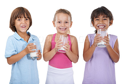Buy stock photo A group of three young children holding glasses of milk
