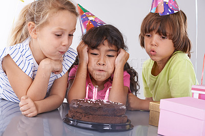 Buy stock photo Friends, kids and birthday cake, blow candles at party with people for celebration, youth and dessert. Special day, together in festive mood and children smile for social event with chocolate