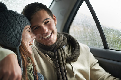 Buy stock photo Love, raining and couple in car for road trip together, laughing on date for travel, vacation or romance. Smile, winter or weather with man and woman in backseat of taxi for holiday trip or journey