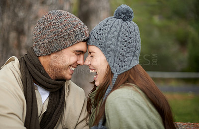 Buy stock photo Face, love and laughing with couple on park bench for vacation, romance or bonding together outdoor. Smile, happy or funny with young man and woman dating or having fun in nature with winter weather