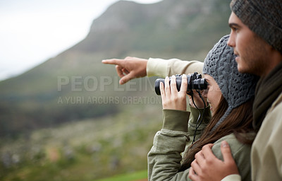 Buy stock photo Couple with binoculars, nature and mountains for travel journey, adventure and hiking or explore together. Man and woman trekking, pointing with outdoor search, vision or birdwatching lens in tourism