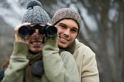 Buy stock photo Binoculars, nature and happy couple in forest, journey and adventure in hiking portrait for carbon footprint travel. Face of young man and woman with outdoor gear for birdwatching in winter and woods