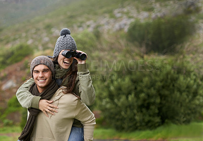 Buy stock photo A young couple taking in all the scenary while enjoying a mountain hike