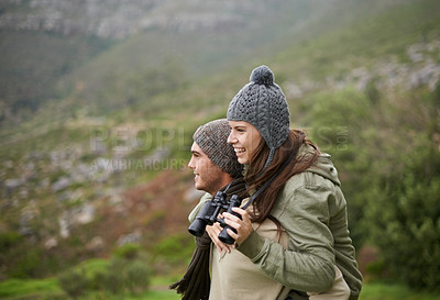 Buy stock photo Nature hiking, binocular and happy couple on piggyback ride, having fun and enjoy mountain climbing journey. Marriage, love and people looking at adventure destination, trekking view or bird watching