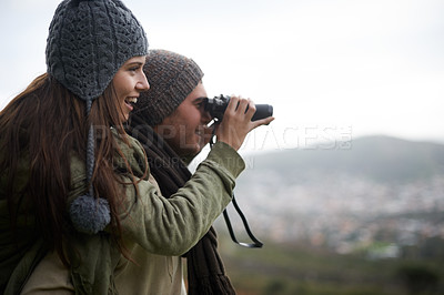 Buy stock photo Couple, travel and binoculars on mountains for journey, adventure and hiking or explore together with cityscape. Man and woman trekking with outdoor search, vision or birdwatching lens in tourism