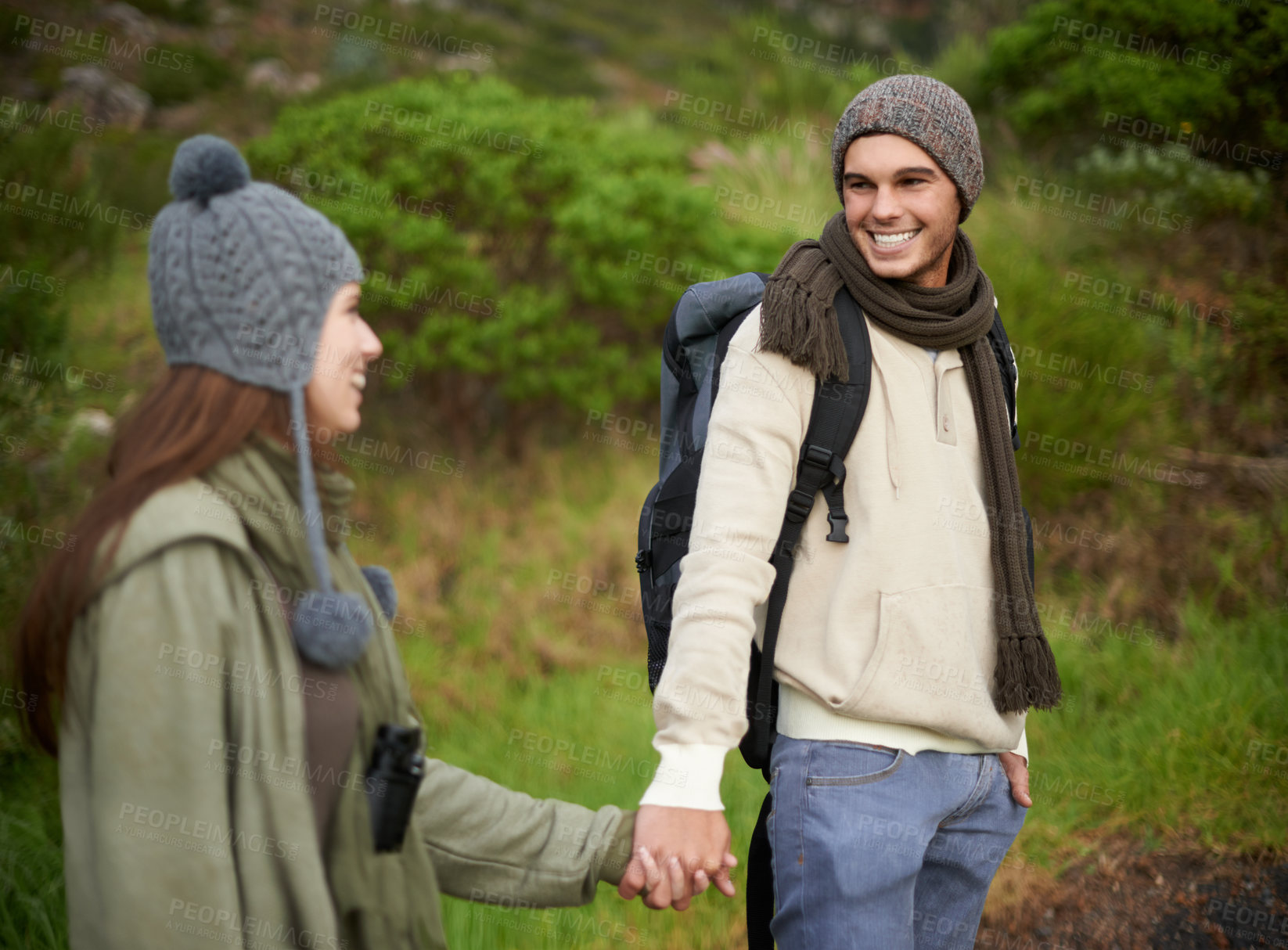 Buy stock photo Woods, hiking and happy couple holding hands on mountain and travel with backpack, nature and bonding. Outdoor, adventure and trekking in path, forest and winter for travelling and explore together