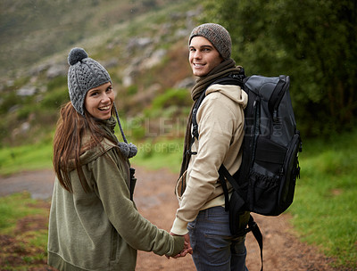 Buy stock photo Happy couple, hiking on mountains and holding hands for outdoor adventure, travel journey and portrait. Young man and woman with love, eco friendly date and walking or trekking in backpack for winter