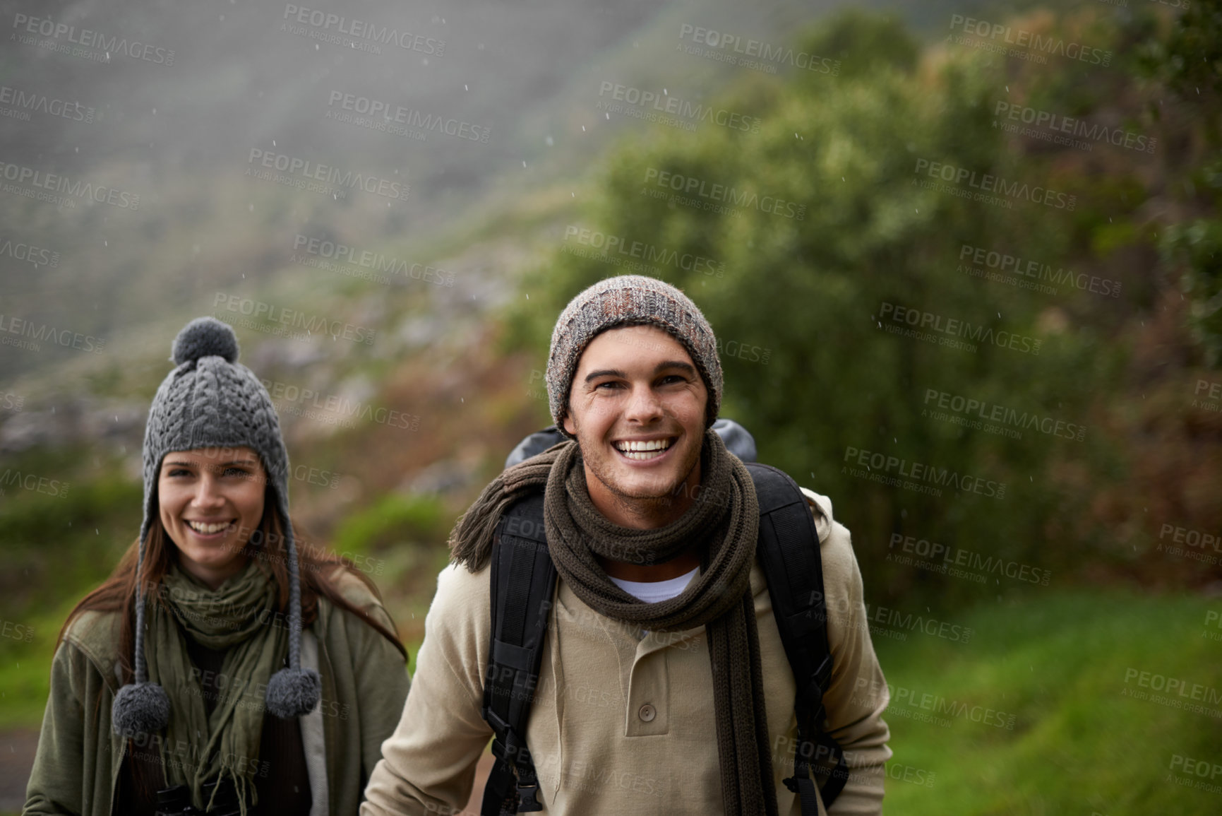 Buy stock photo Portrait, hiking and happy with couple, tourist and walking with backpack, mountain and bonding together. Outdoor journey, adventure and trekking in path, field and exercise for fitness and travel
