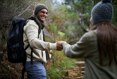 Buy stock photo Happy couple, hiking in nature and holding hands for outdoor adventure, travel and journey in forest or eco woods. Young man woman with love, support and walking or trekking in backpack for winter