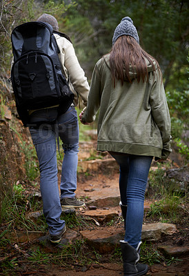 Buy stock photo Couple, hiking in nature and holding hands for outdoor adventure and travel journey in a forest or eco woods. Back of People with love, support and walking or trekking in backpack on mountains path