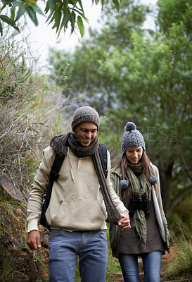 Buy stock photo Couple, happy and hiking in forest or holding hands with travel, adventure and nature for wellness or fitness. Man, woman and trekking in woods for cardio, exercise or workout with view or backpack