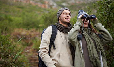 Buy stock photo Couple, travel in nature and binoculars for hiking, adventure and journey or explore together in eco friendly mountains. Happy man and woman trekking with outdoor search, vision or birdwatching lens