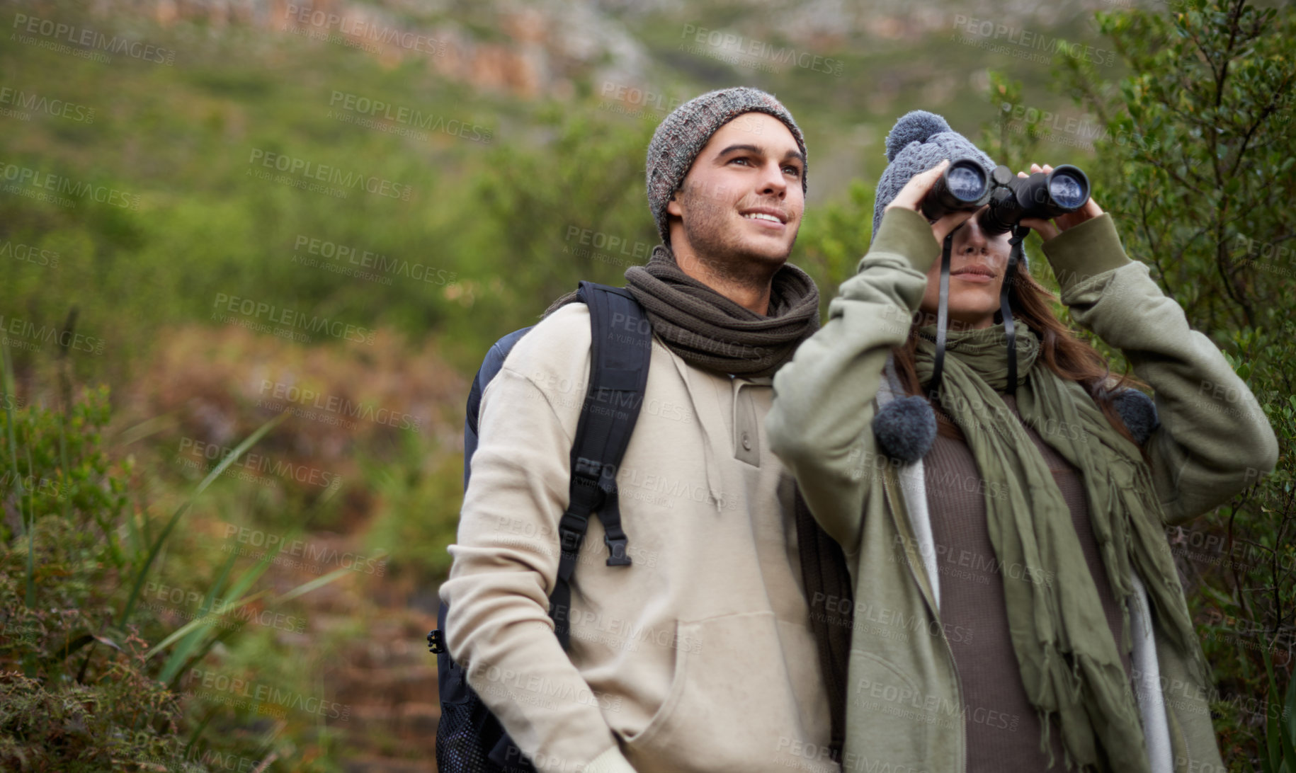 Buy stock photo Couple, travel in nature and binoculars for hiking, adventure and journey or explore together in eco friendly mountains. Happy man and woman trekking with outdoor search, vision or birdwatching lens