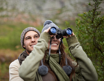 Buy stock photo Couple, love and binocular in nature for travel, adventure or hiking journey and explore together in eco friendly mountains. Happy man and woman trekking with outdoor search, vision or birdwatching