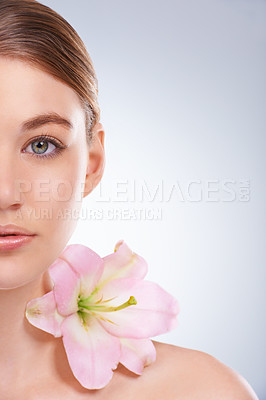 Buy stock photo Half face, woman and dermatology with flowers, beauty and wellness on white studio background. Closeup, portrait or model with natural cosmetics or grooming with shine or glow with skincare or smooth
