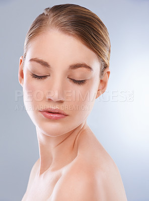Buy stock photo Studio shot of a bare-shouldered young model with her eyes closed